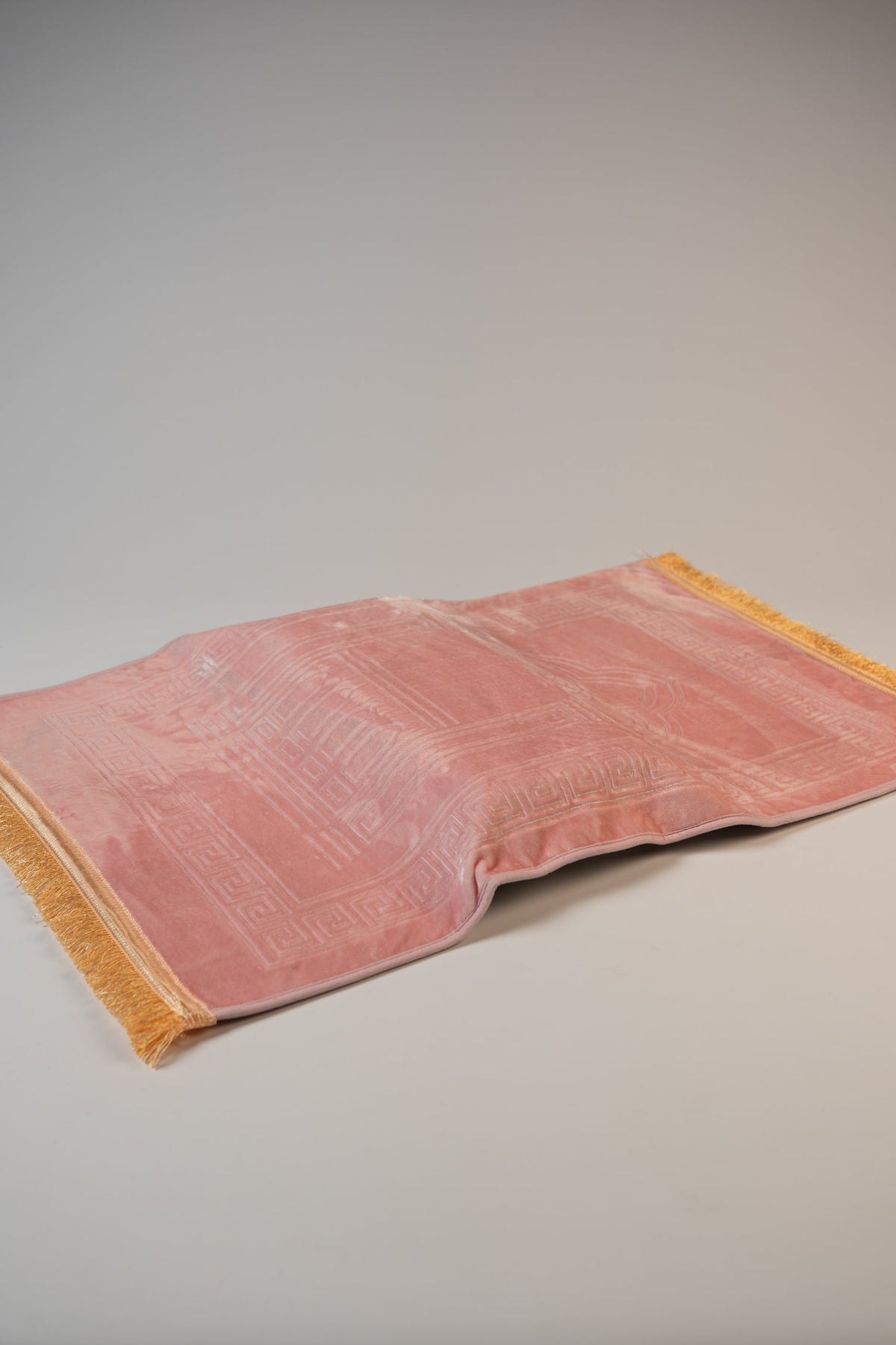 Ergonomic prayer mat in Pink, angled view