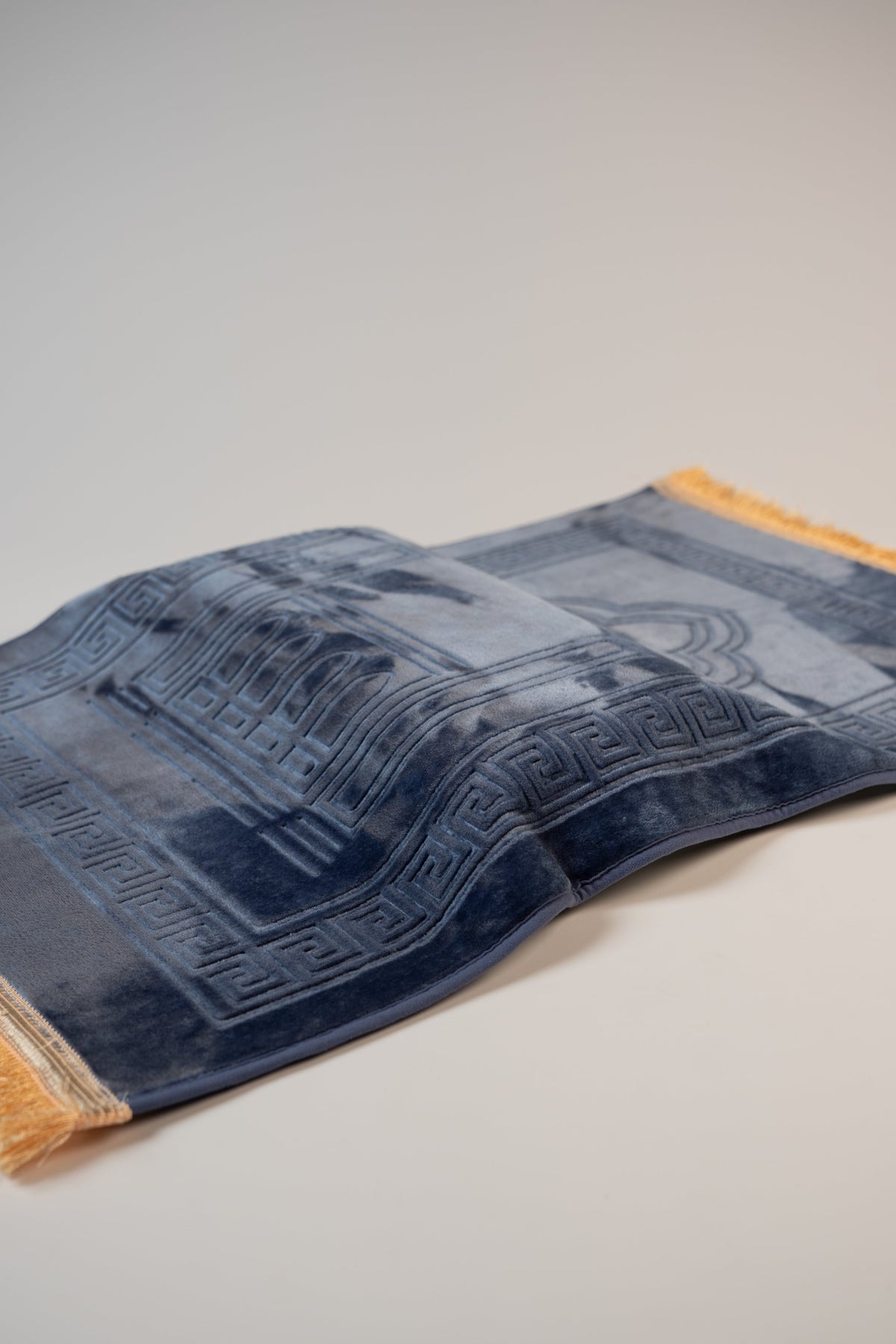 Ergonomic prayer mat in Navy Blue, side view of the padded knee cushion